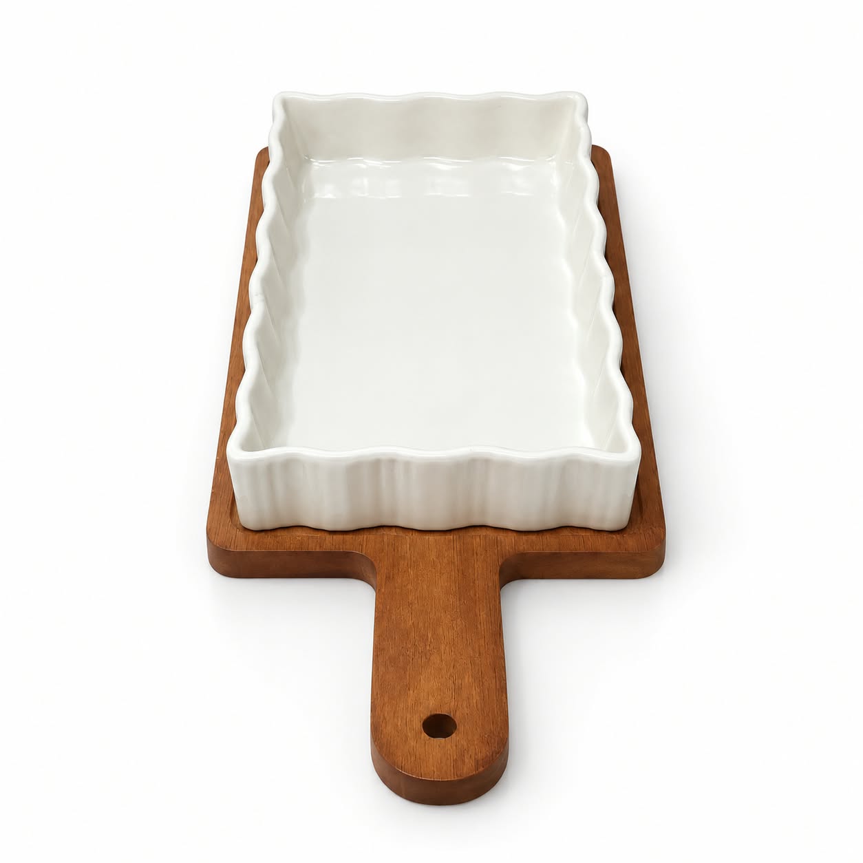 White ceramic baking dish with wooden serving tray
